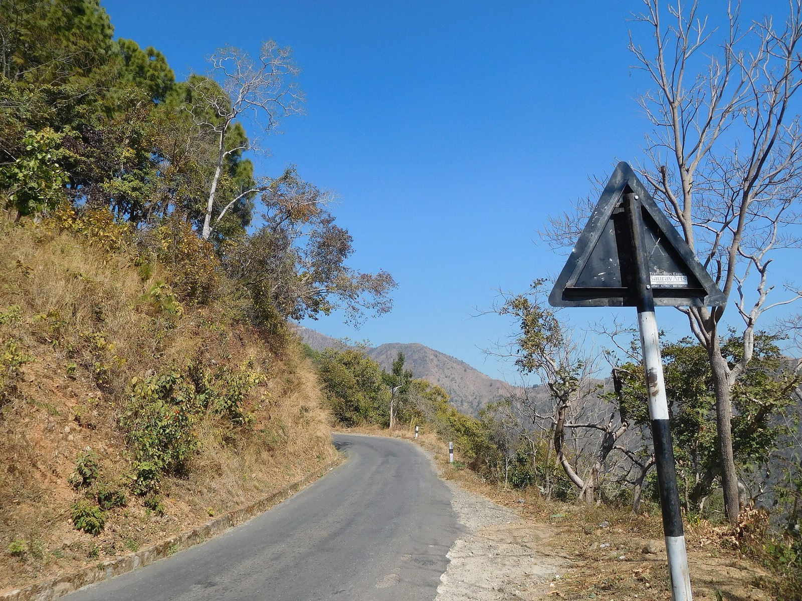 A paved hill road curving along a slope in Dailekh district