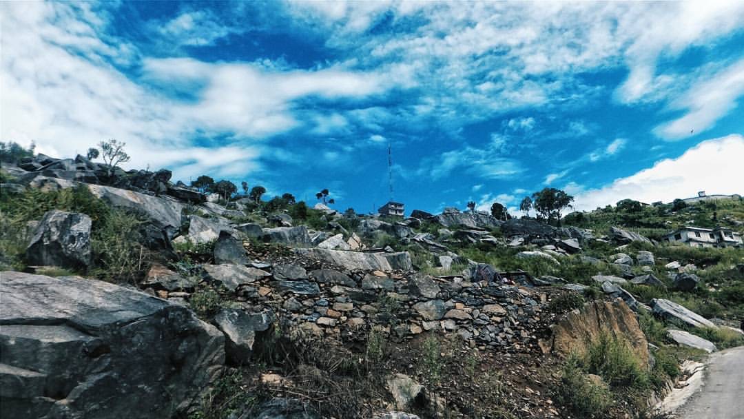 A road cut into a rock face above Mangma Bazar in Kalikot district